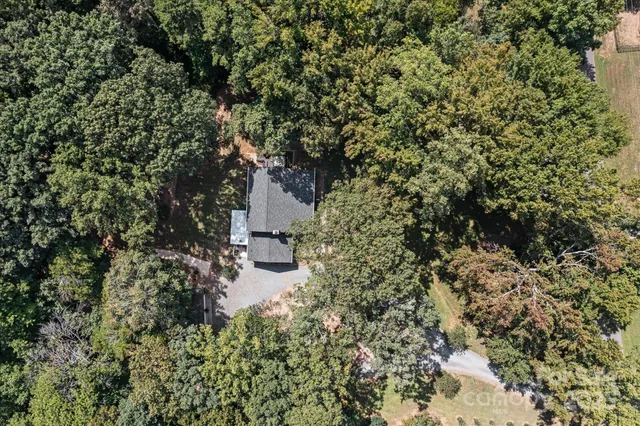 a backyard of a house with wooden floor and fence