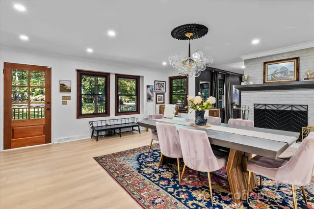 a view of a dining room with furniture wooden floor and chandelier