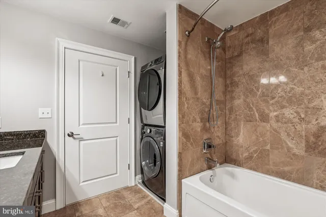 a bathroom with a tub a sink and a shower