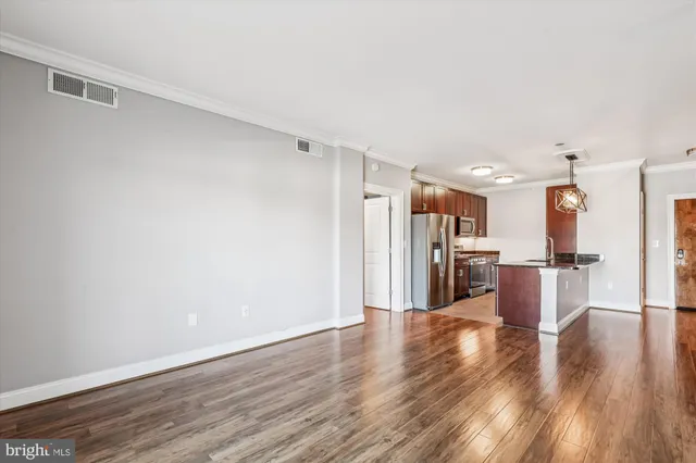 a view of kitchen with refrigerator microwave and wooden floor