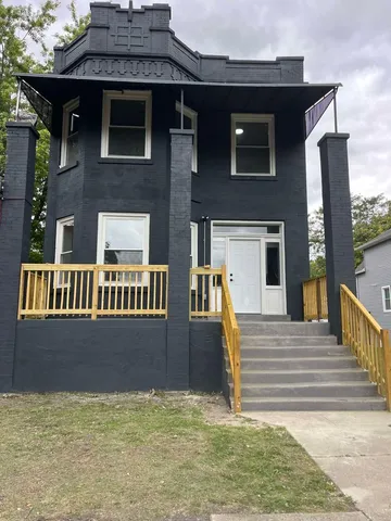 a front view of a house with lots of green space