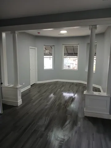 a view of room with window and hardwood floor