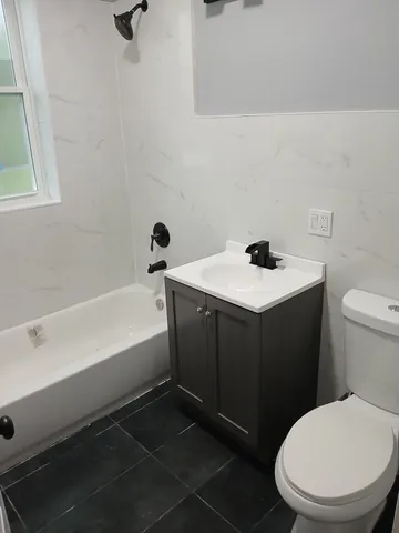 a bathroom with a sink toilet and vanity