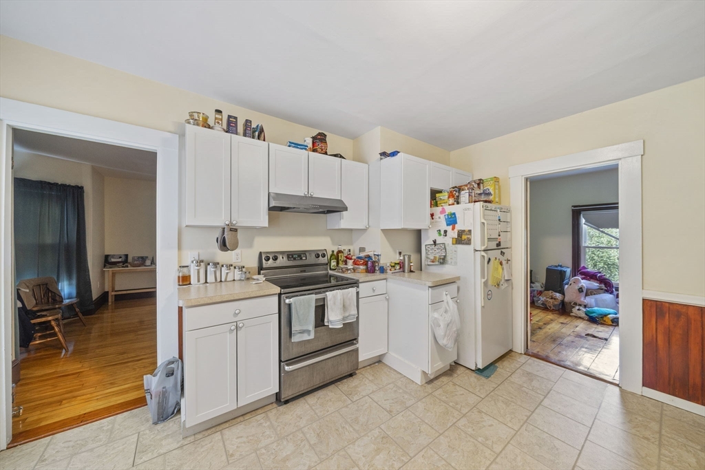 96 Plymouth Street, Unit 2 Abington, MA 02351 - Photo 8 of 9 a kitchen with white cabinets and white appliances