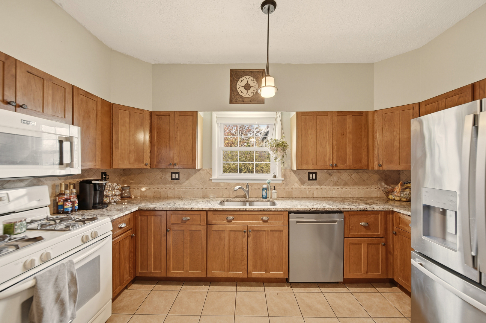 316 East 3rd Street Dixon, IL 61021 - Photo 16 of 45 a kitchen with a sink stove and refrigerator