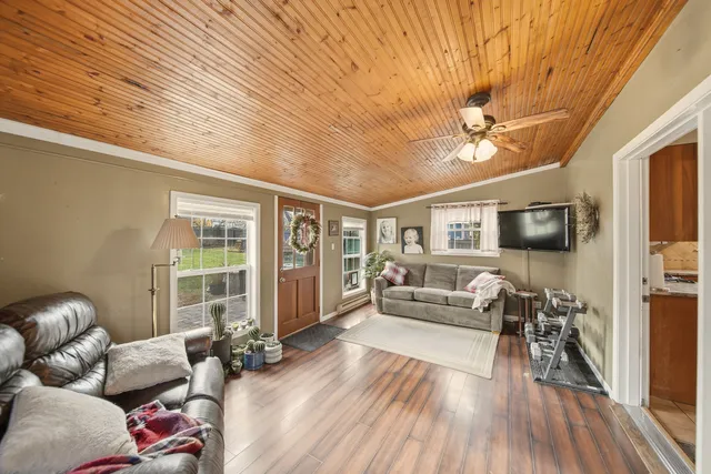 a living room with furniture and a wooden floor