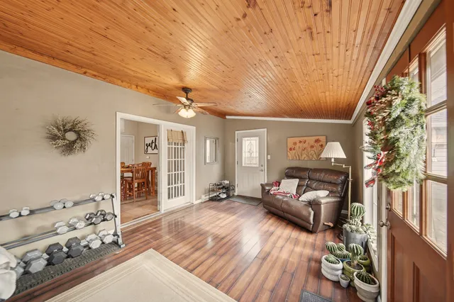a living room with furniture and wooden floor