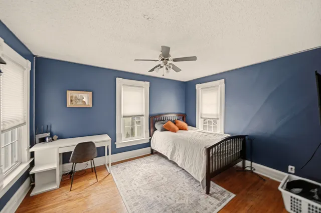 a bedroom with a bed and a chandelier