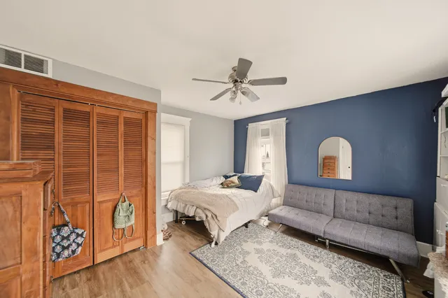 a bedroom with a bed and a couch