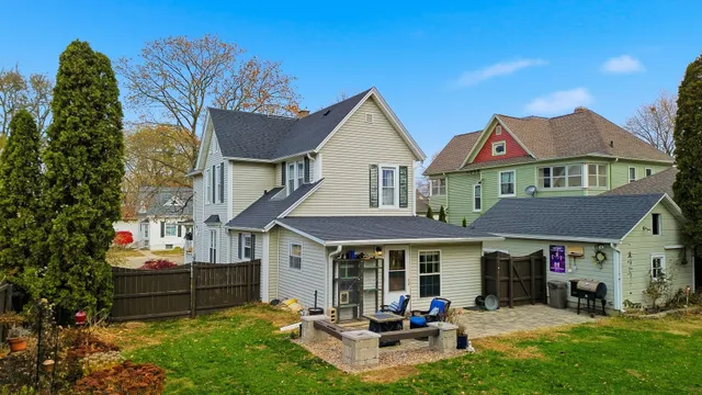 a view of a house with a patio and a yard