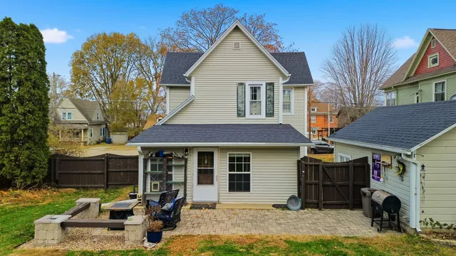 a front view of a house with a yard and outdoor seating