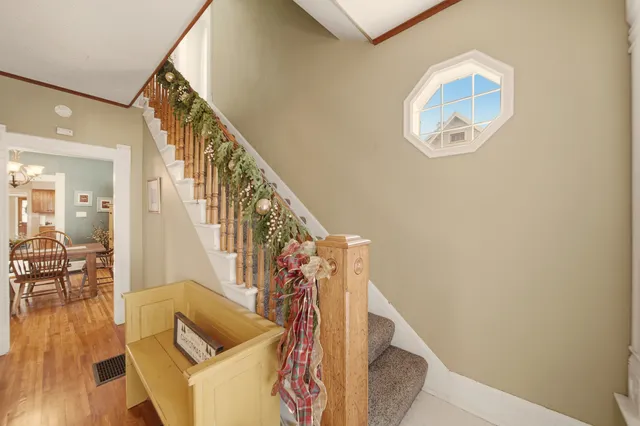 a view of entryway and hall with wooden floor