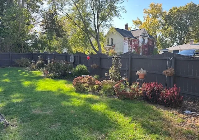 a view of a house with a yard and garden
