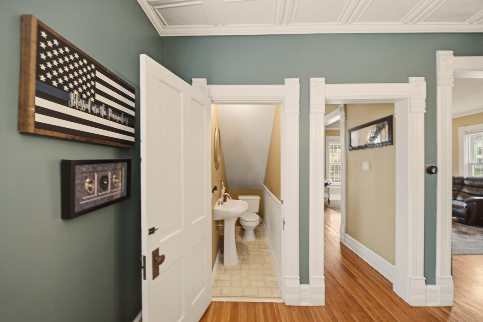 316 East 3rd Street Dixon, IL 61021 - Photo 10 of 45 a view of a hallway with wooden floor and a living room