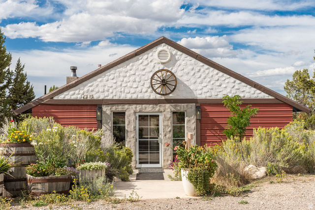 11550 Pigeon Hollow Road Spring City, UT 84662 - Photo 25 of 85 Gable roofline featuring textured white siding and a decorative wagon wheel accent