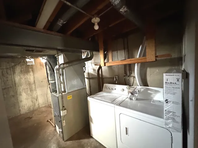 a kitchen with stainless steel appliances granite countertop a sink and a refrigerator