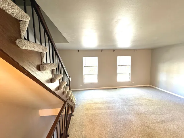 a view of empty room with stairs