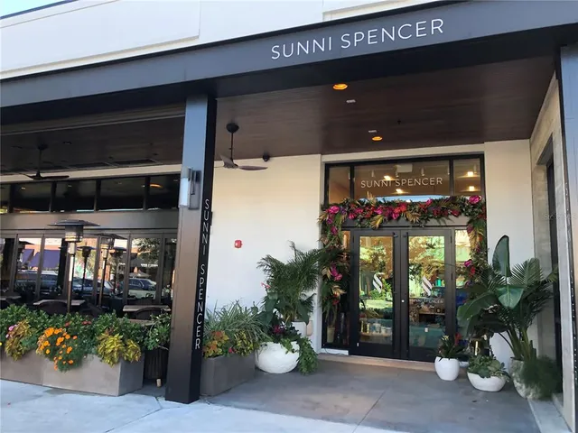 a front view of a house with plants