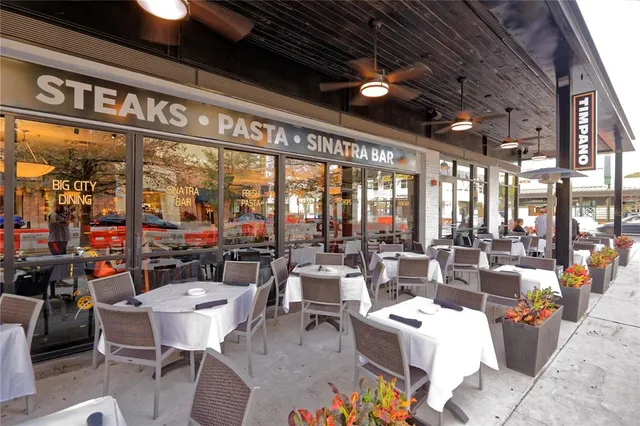 a living room with lots of furniture and a large window