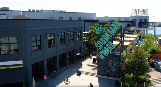 a front view of a multi story building with yard and outdoor seating