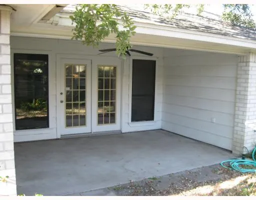 front view of a brick house with a large window