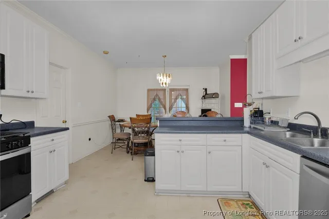 a kitchen with sink cabinets and stove top oven