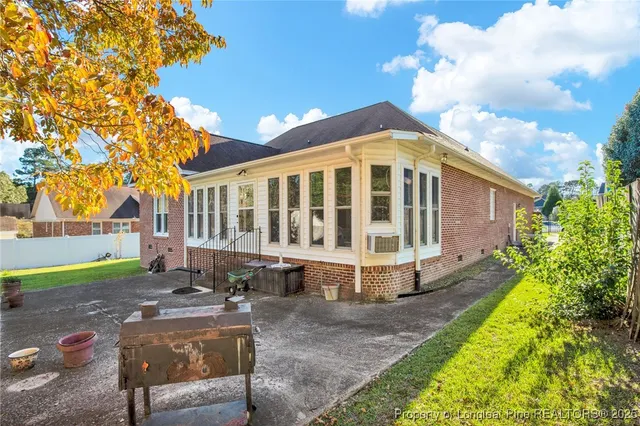 a view of a house with backyard and sitting area