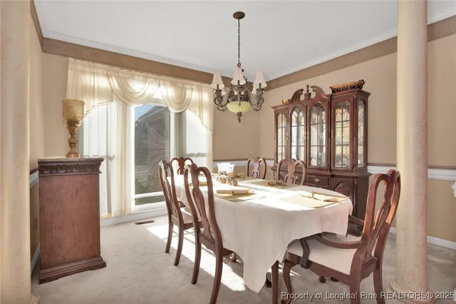 a view of a dining room with furniture and window