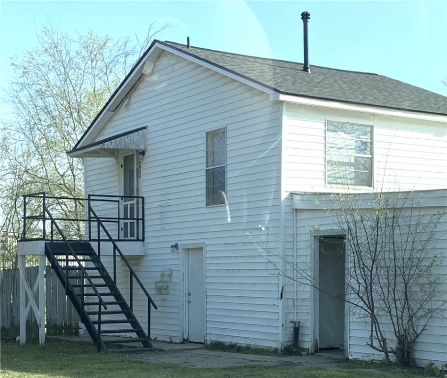 a front view of a house with wooden stairs
