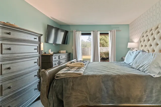 a bedroom with a bed and a mirror