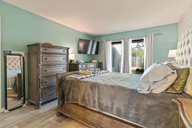 a bedroom with a bed and a mirror