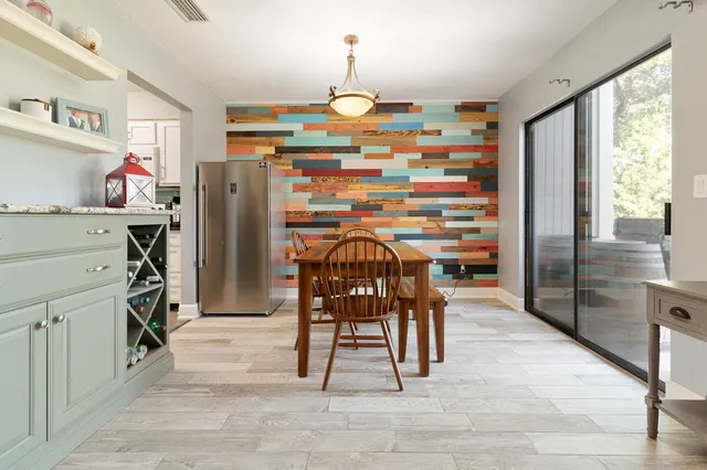 a dining room filled with furniture and a chandelier