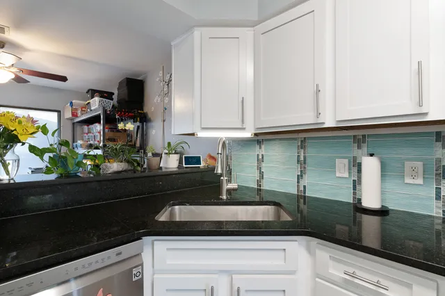 a kitchen with a sink and cabinets
