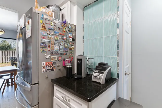 a bathroom with a granite countertop sink a toilet a mirror a bathtub and shower