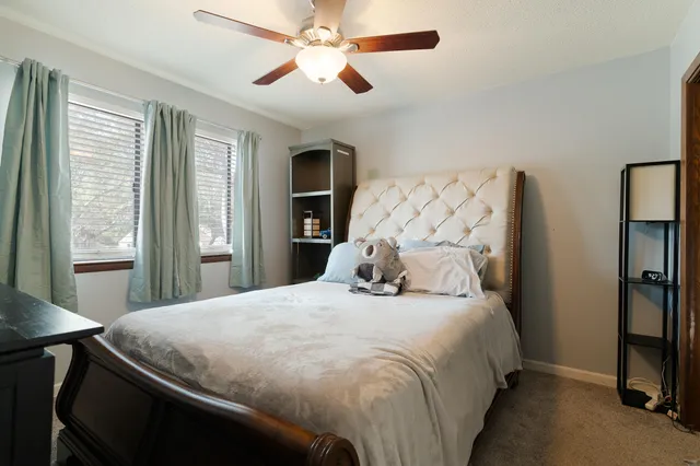 a bedroom with furniture and a book shelf