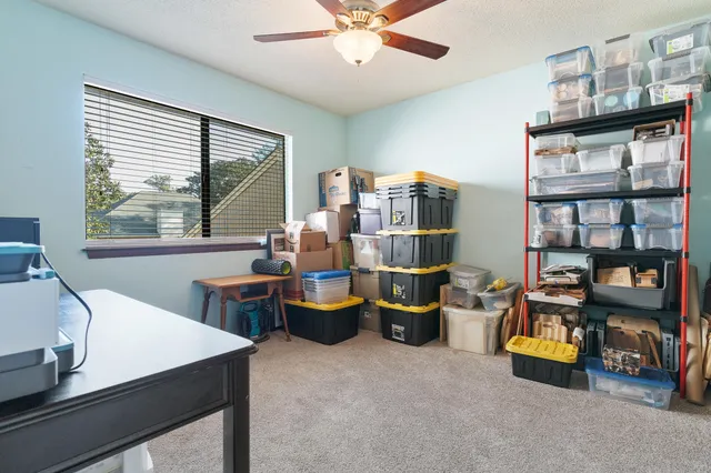 a room with stainless steel appliances kitchen island granite countertop furniture and a refrigerator