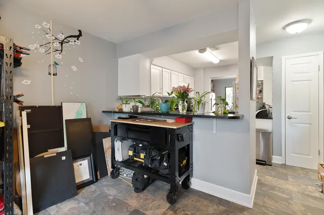 a view of two chairs and a tables in the patio
