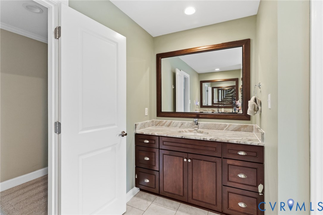 15220 River Road Chesterfield, VA 23838 - Photo 38 of 65 Bathroom vanity featuring a dark wood-finish cabin