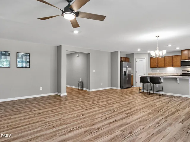 a view of a livingroom with furniture and a ceiling fan