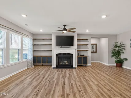 a living room with a fireplace and a floor to ceiling window