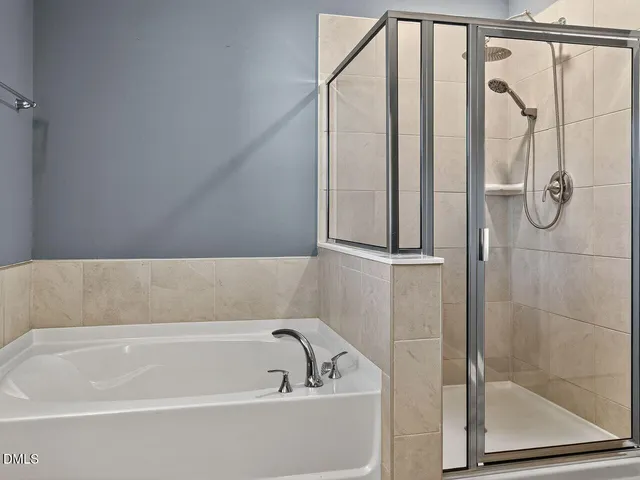 a bathroom with a bathtub and shower