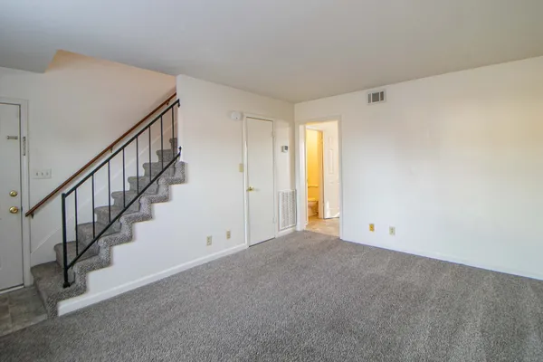 a view of an empty room with stairs