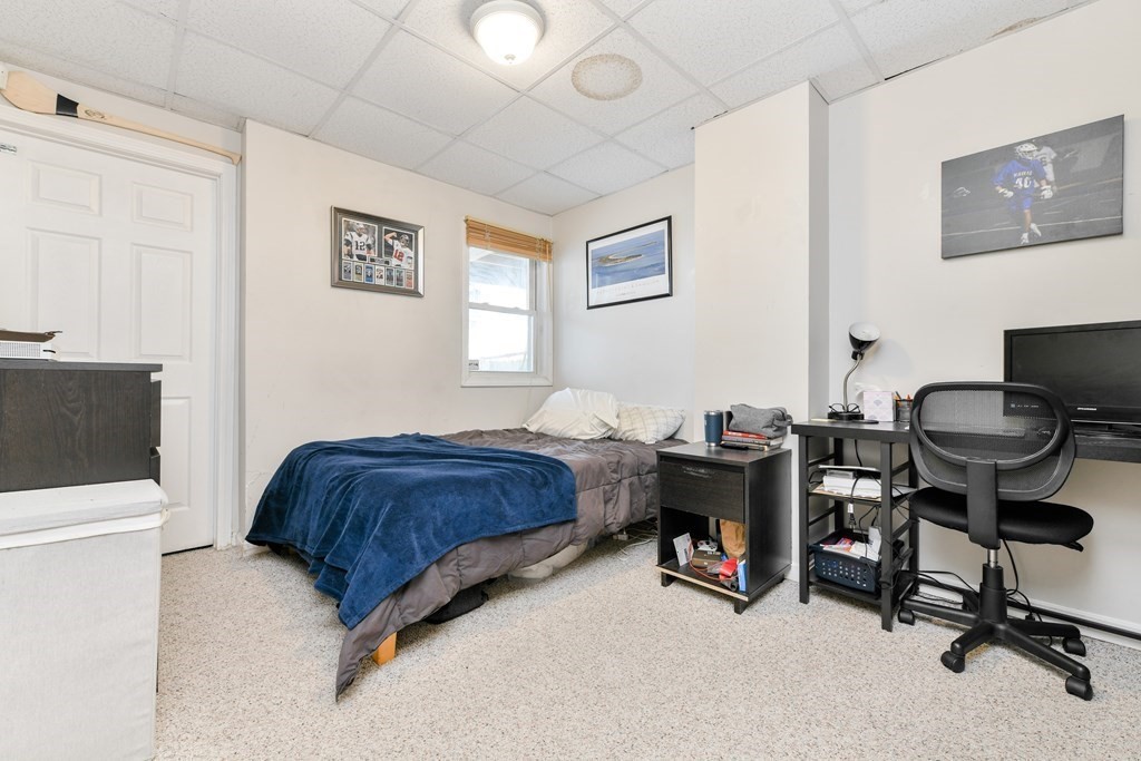 748 East 3rd Street, Unit A Boston, MA 02127 - Photo 7 of 16 a bedroom with a bed and a chair in it