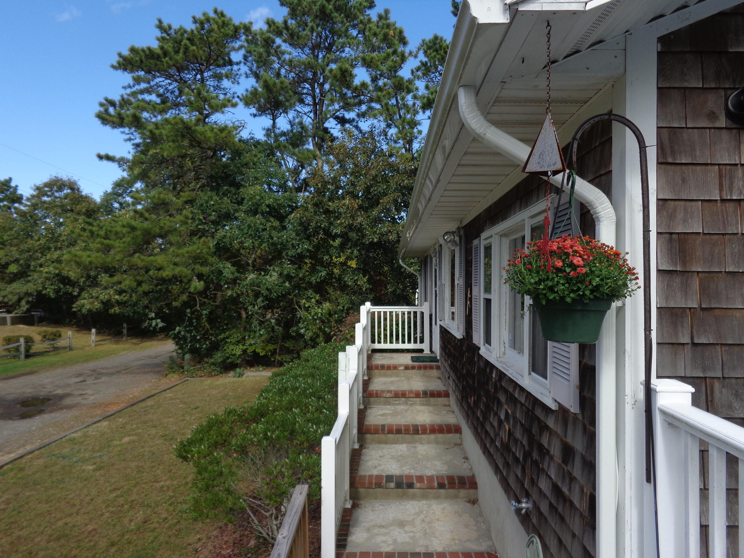 6 Huckleberry Lane Dennis Port, MA 02639 - Photo 3 of 23 a view of a house with wooden stairs