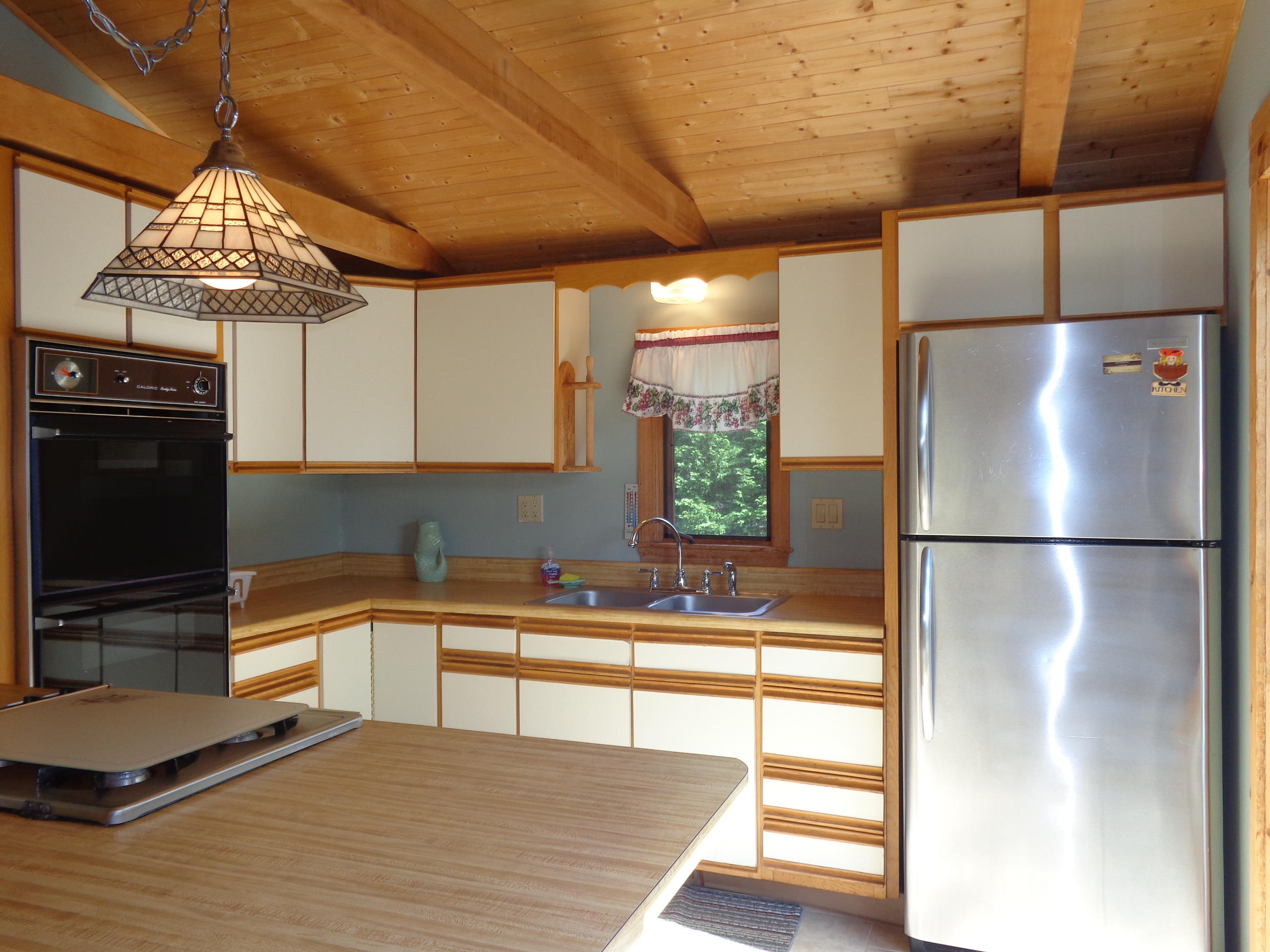 6 Huckleberry Lane Dennis Port, MA 02639 - Photo 7 of 23 a kitchen with stainless steel appliances a refrigerator and a stove top oven