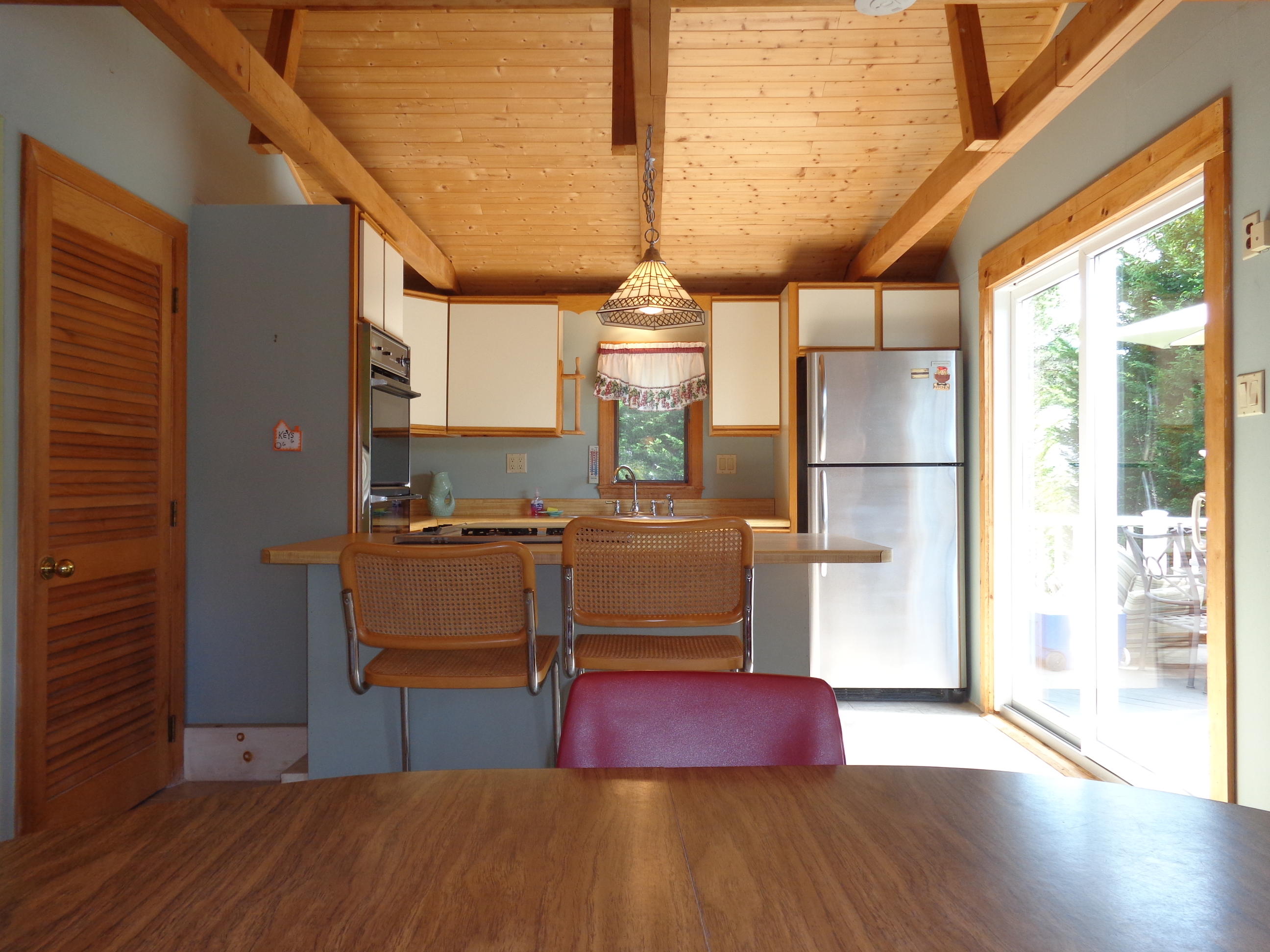6 Huckleberry Lane Dennis Port, MA 02639 - Photo 8 of 23 a hallway with a dining table and chairs