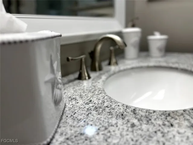 a view of a tennis ground with chairs