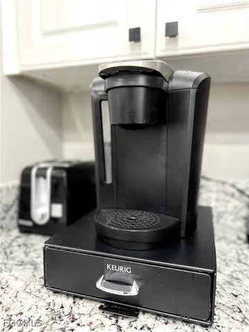 a bathroom with a granite countertop sink a toilet and a mirror