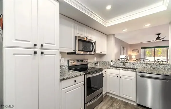 a kitchen with a sink stove and microwave