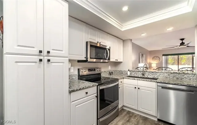 a kitchen with a sink stove and microwave